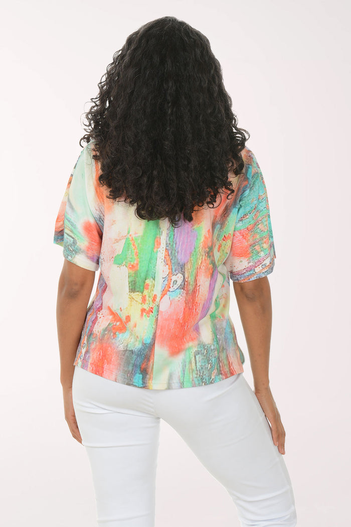 Woman wearing a colorful blouse with a white background