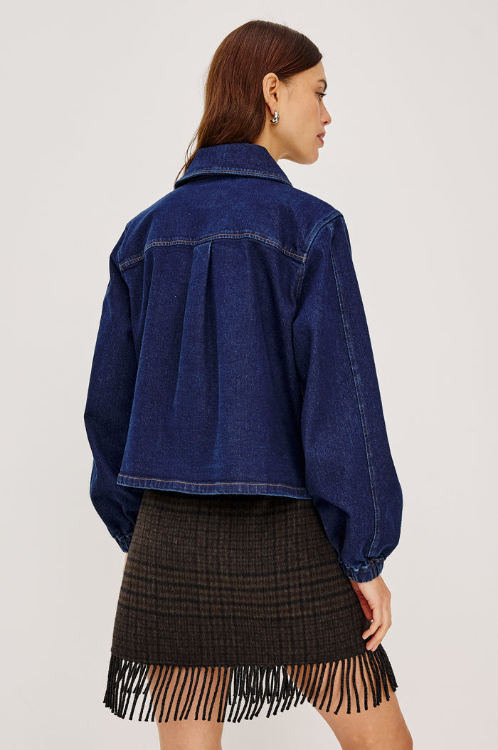 Brooke Jacket in Midweight Denim With Duffel Slightly Cropped Fit, Long Balloon Sleeves, Elastic Cuffs, Back Yoke Pleat, and Front Toggle Closures in Rinse Indigo Colorway - Upper Body Back View Featured on Model