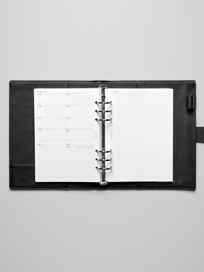 Image shows the Monday Start 2026 Dated Weekly Admin Planner Insert in a black leather ring-bound planner.