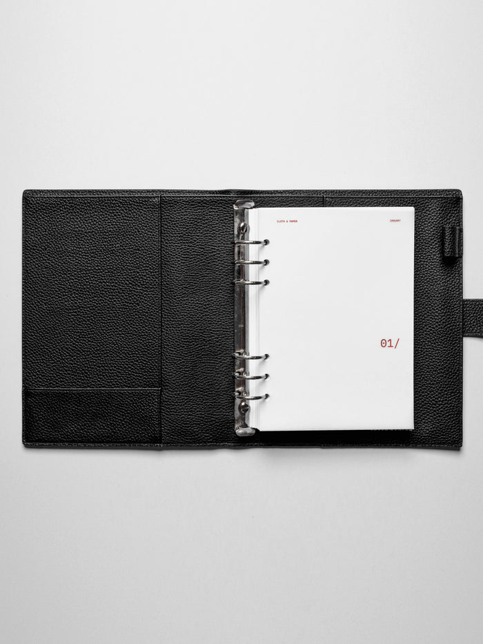 Image shows the January dashboard used in a black A5 ring-bound leather folio.