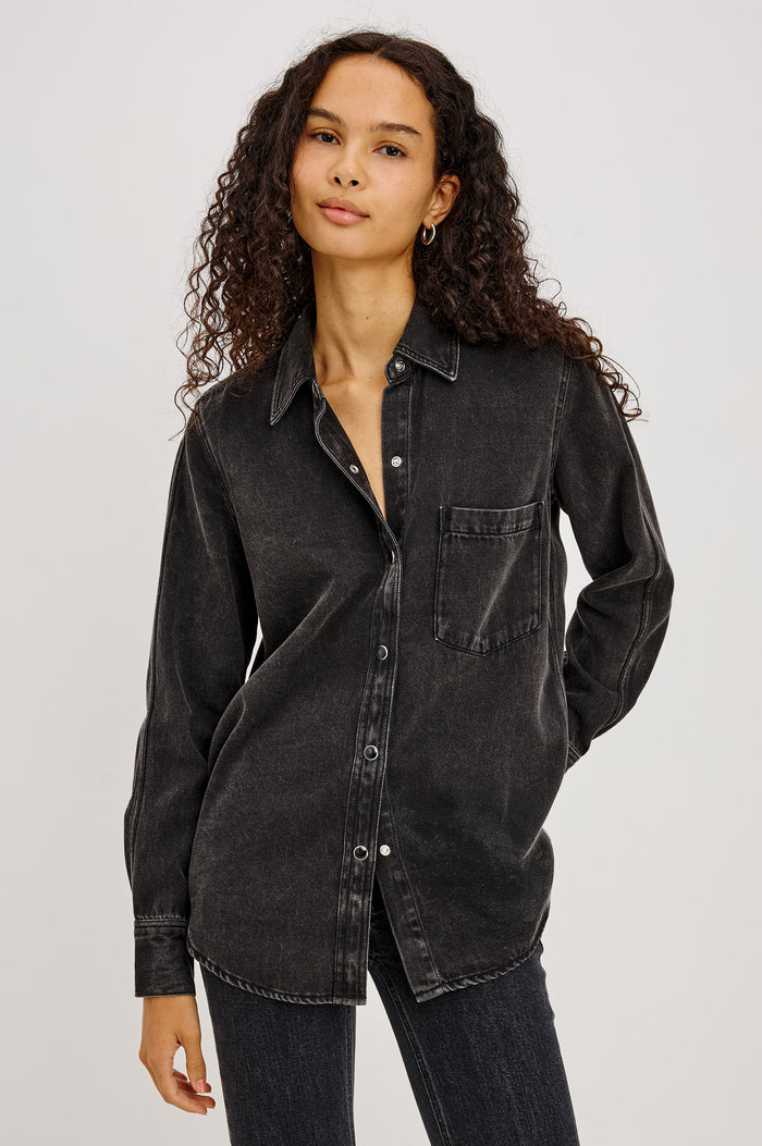 Atticus Shirt in Soft TENCELâ„¢ Denim With Relaxed Fit, Point Collar, Front Button, and Long Sleeves With Flat-Felled Seams and Buttoned Cuffs in Washed Black Colorway - Upper Body Front View Featured on Model
