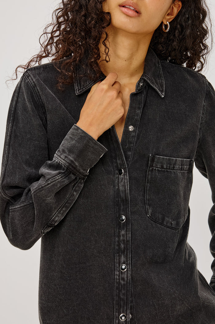 Atticus Shirt in Soft TENCELâ„¢ Denim With Relaxed Fit, Point Collar, Front Button, and Long Sleeves With Flat-Felled Seams and Buttoned Cuffs in Washed Black Colorway - Upper Body Close Up View Featured on Model