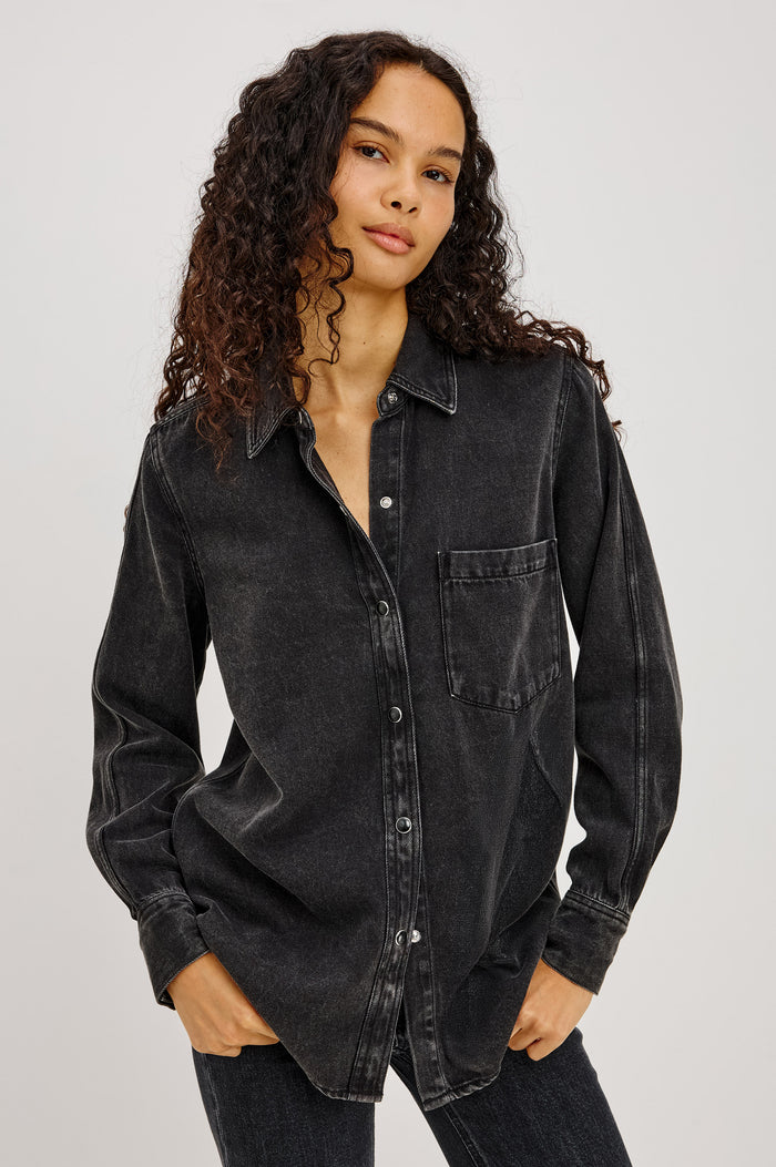 Atticus Shirt in Soft TENCELâ„¢ Denim With Relaxed Fit, Point Collar, Front Button, and Long Sleeves With Flat-Felled Seams and Buttoned Cuffs in Washed Black Colorway - Upper Body Front View Featured on Model