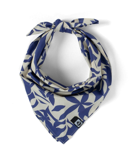 The Balance - Bandana - Blue by Saltrock features a beige 100% cotton fabric with a blue leaf pattern, a square cut, and a small black and white tag sewn onto one corner, adding to its unique charm.