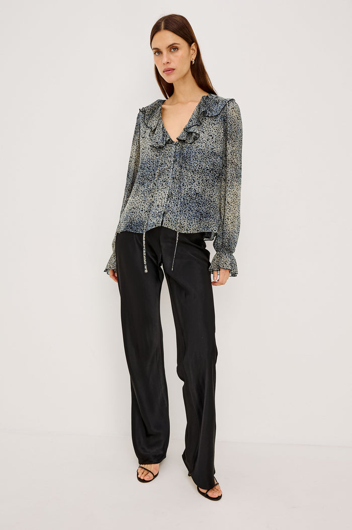 Becky Shirt in Self-Lined Chiffon With Deep V-Neckline, Ruffle Collar, Center Front Self-Tie, Long Sleeves, and Elastic Ruffle Cuffs in Agate Colorway - Full Body Front View Featured on Model