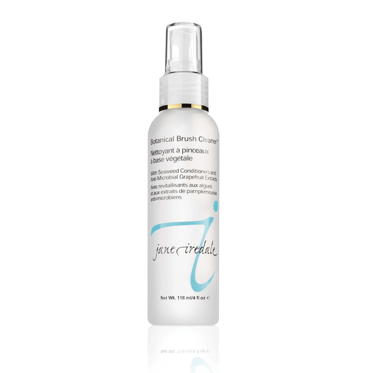White spray bottle of Botanical Brush Cleaner™ | Jane Iredale with light blue logo and text highlighting seaweed conditioners and grapefruit extract for brush cleansing and skincare maintenance.