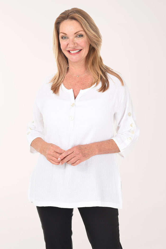 Woman wearing a white blouse with a plain background