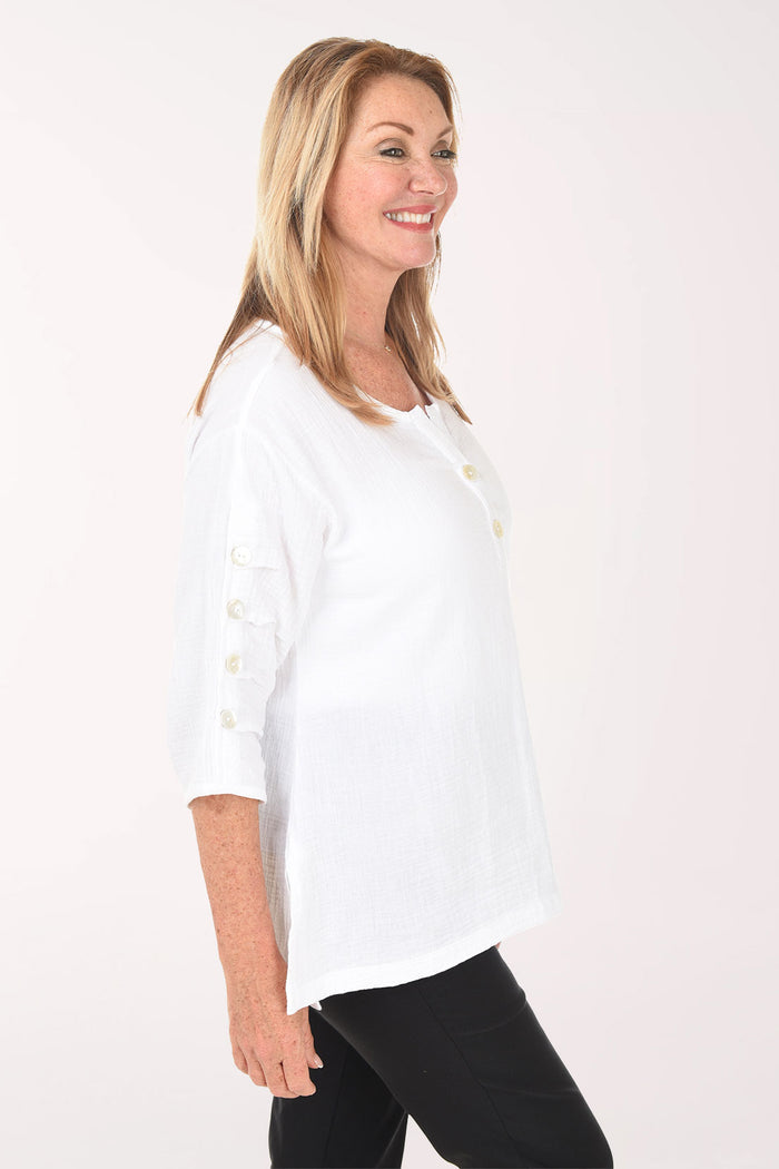 Woman wearing a white blouse with a plain background