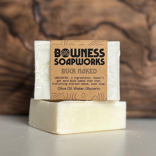 Unscented Buck Naked soap made in Calgary by Bowness Soapworks, shown stacked with kraft label on a neutral background