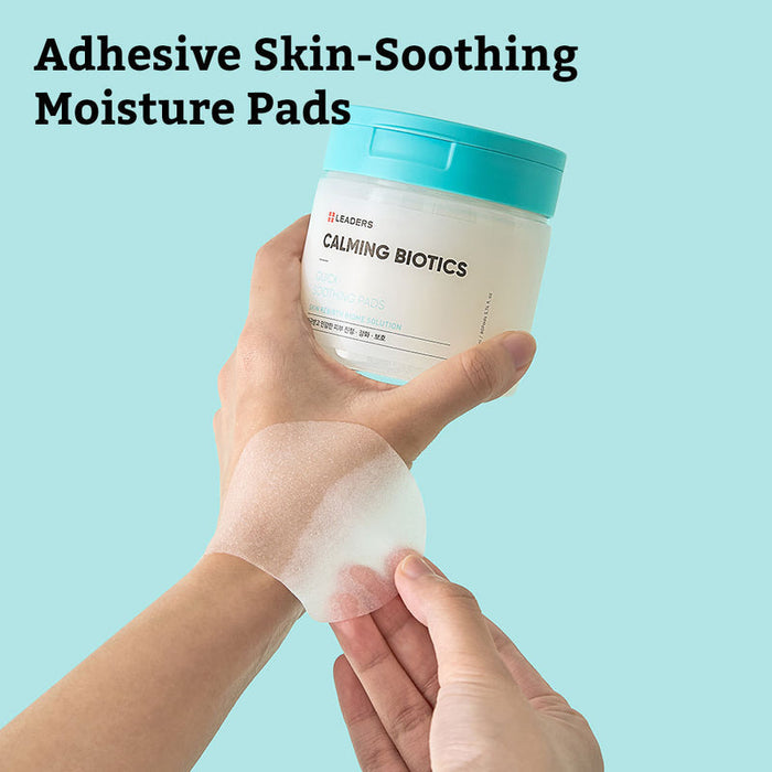 Hand holding a jar of Calming Biotics Quick Soothing Pads | Leaders with a translucent adhesive moisture pad applied on the wrist against a light blue background.