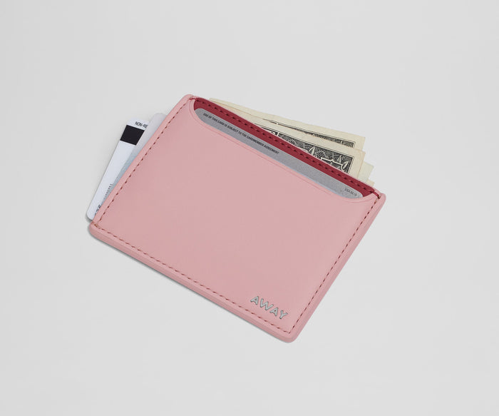 Card case filled with money and credit cards