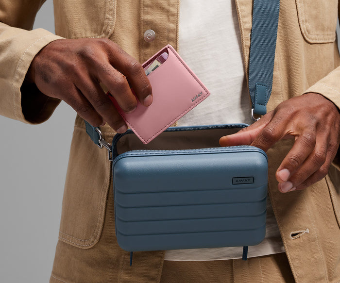Card case being packed inside The Mini Crossbody
// With its slim, compact design, the Card Case slips effortlessly into your pocket or bag. Paired with The Mini Crossbody.