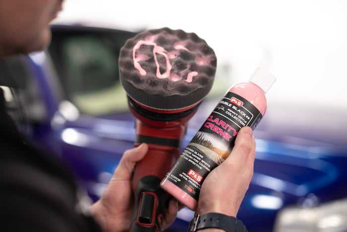 Person holding a polisher with Clarity creme on it and a bottle of Clarity Creme.