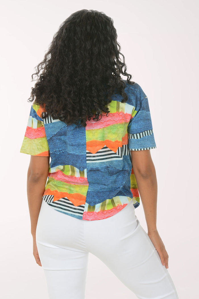 Woman wearing a colorful striped shirt and white pants on a white background