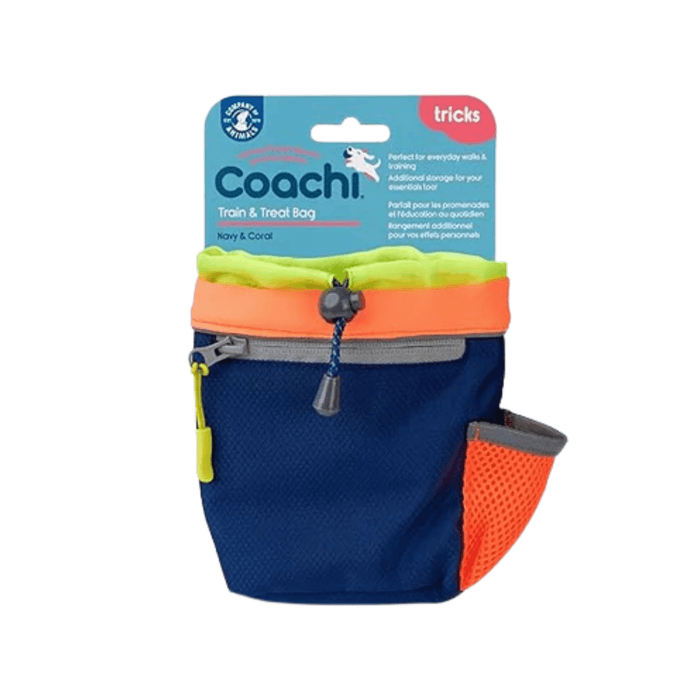 White background with a a Coachi Train and Treat pouch in navy and coral with a blue tag attached to the top.