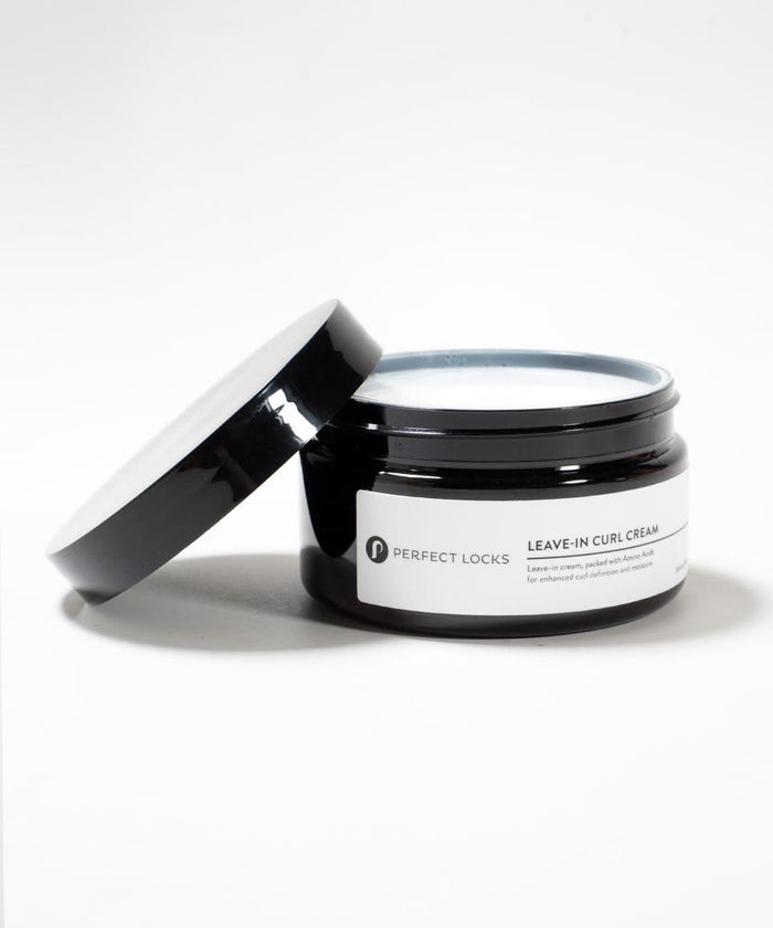 A black jar of Perfect Locks Leave-In Curl Cream with a white label and open lid on a white background, highlighting its curl formula.