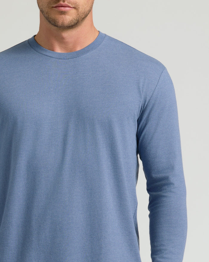 Man wearing Dark Heather Vintage Navy Classic Long Sleeve Crew Neck.