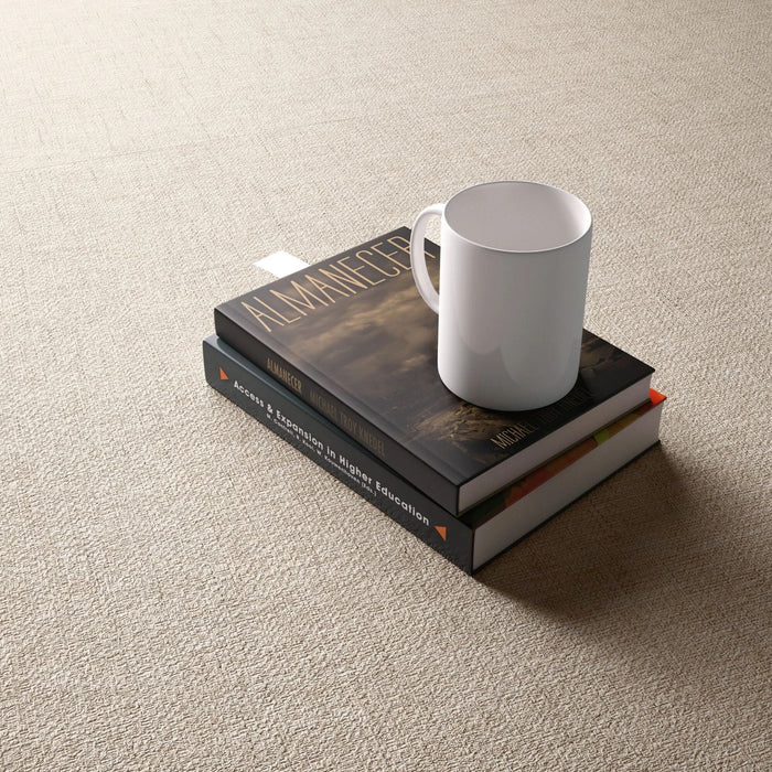 Beige fabric effect tile with a white cup and books.