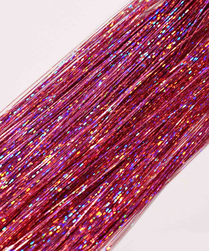 Soft purple Perfect Hair Tinsel by Perfect Locks with iridescent multicolored glitter, blending into Remy hair on a light background.#color_pink-flamingo