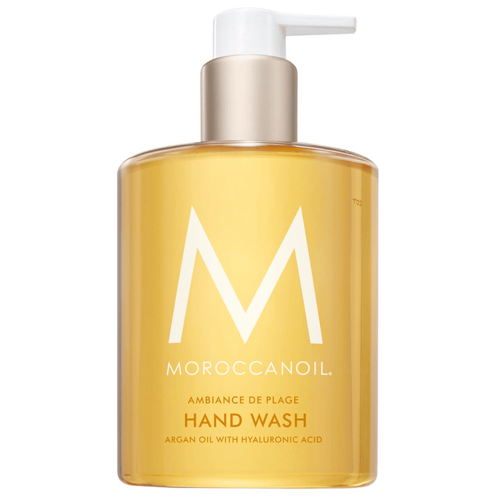 Clear amber liquid hand wash in a pump bottle labeled Hand Wash | Moroccanoil, featuring argan oil and hyaluronic acid for skincare and body care.
