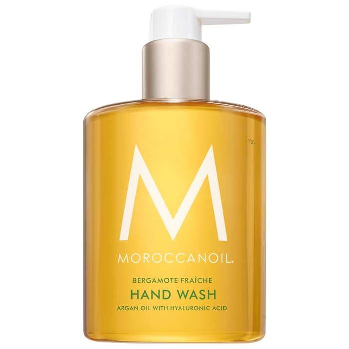 Clear amber bottle with a white pump containing Hand Wash | Moroccanoil featuring argan oil and hyaluronic acid, designed for skincare and body care wellness.