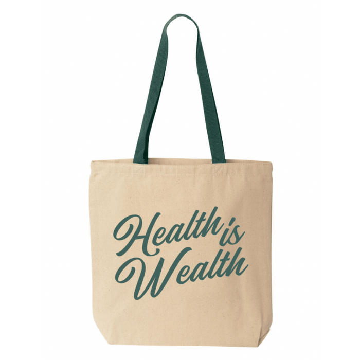 Canvas tote bag with green handles featuring the phrase "Health Is Wealth" in green script, named Health Is Wealth Tote | Lucky Owl.