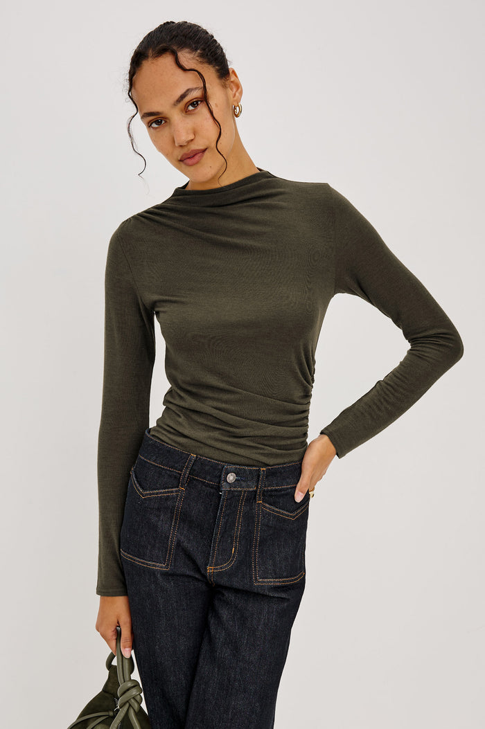 Joelle Top Fitted in Jersey With High Funnel Neckl, Long Sleeves, and Asymmetric Shoulder Shirring in Heather Olive Colorway - Upper Body Front View Featured on Model