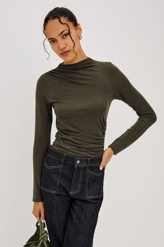 Joelle Top Fitted in Jersey With High Funnel Neckl, Long Sleeves, and Asymmetric Shoulder Shirring in Heather Olive Colorway - Upper Body Front View Featured on Model