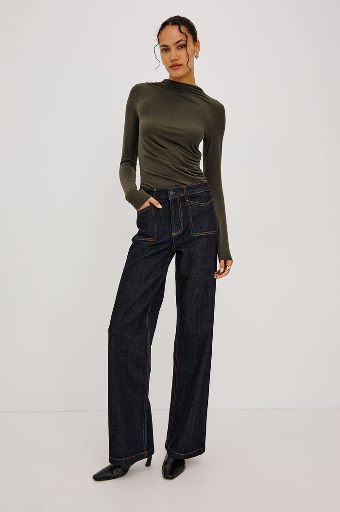 Joelle Top Fitted in Jersey With High Funnel Neckl, Long Sleeves, and Asymmetric Shoulder Shirring in Heather Olive Colorway - Full Body Front View Featured on Model