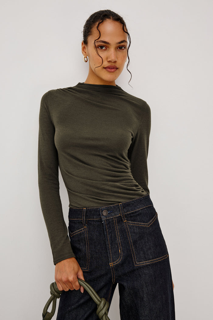 Joelle Top Fitted in Jersey With High Funnel Neckl, Long Sleeves, and Asymmetric Shoulder Shirring in Heather Olive Colorway - Upper Body Front View Featured on Model