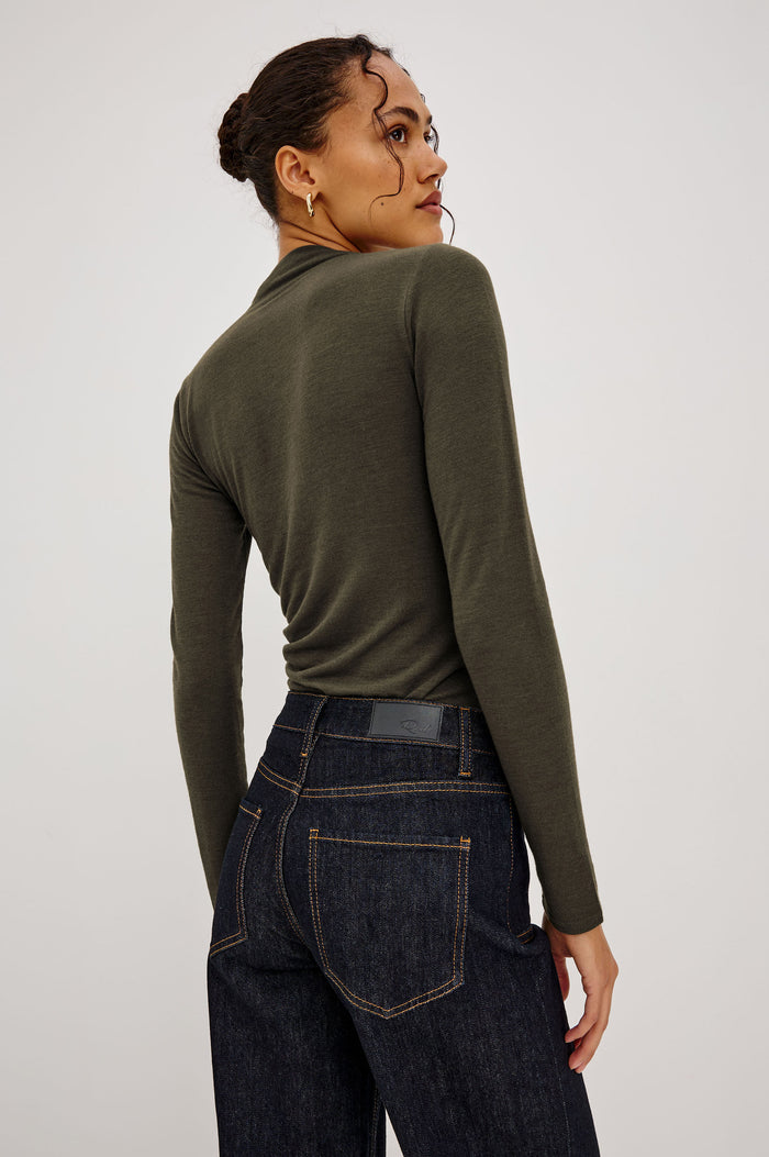 Joelle Top Fitted in Jersey With High Funnel Neckl, Long Sleeves, and Asymmetric Shoulder Shirring in Heather Olive Colorway - Upper Body Back View Featured on Model