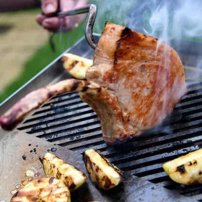Steak being grilled with vegetables on a Kasai Konro Plancha