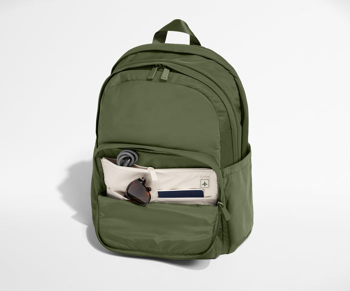 Green backpack with front pocket on a white background