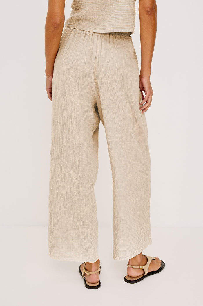 Leon Crop Pant with a Smocked Waistband and Two Front Seam Pockets in Light Brown Heather Flax Colorway - Lower Body Back View Featured on Model