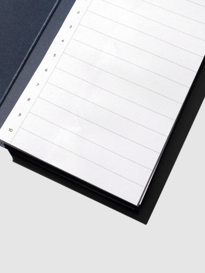 Closeup of sticky note displayed on its backing on a neutral background.