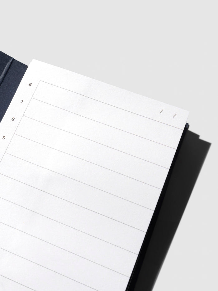 Closeup of sticky note displayed on its backing on a neutral background.