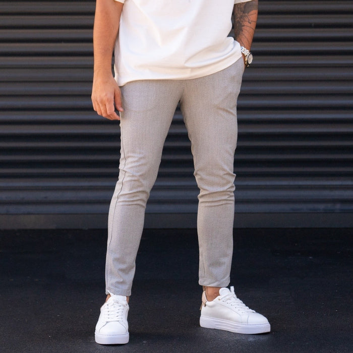 Martin Valen men's slim-fit lycra gray slacks, full-length front view with cropped hem and white platform sneakers