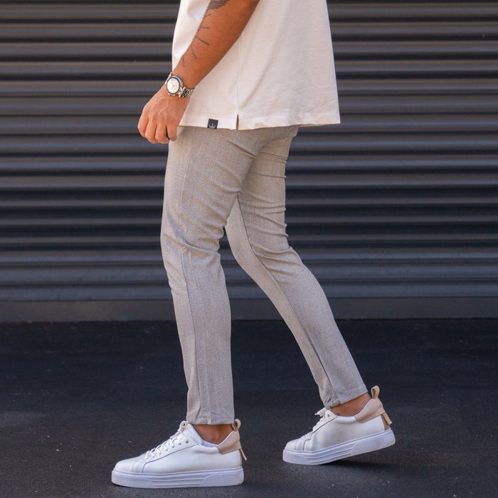 Martin Valen men's slim-fit lycra gray slacks, side walking view showing visible side seam and small side tag with white sneakers