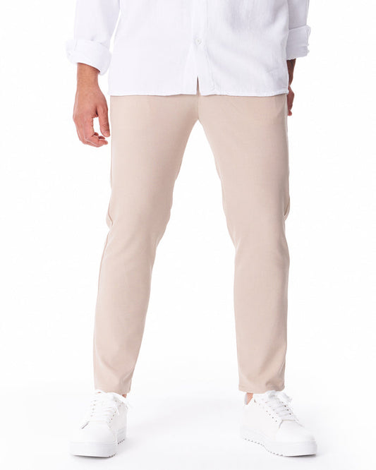 Martin Valen men's light beige trousers in lightweight fabric, front view to mid-thigh with white shirt and ankle hem visible