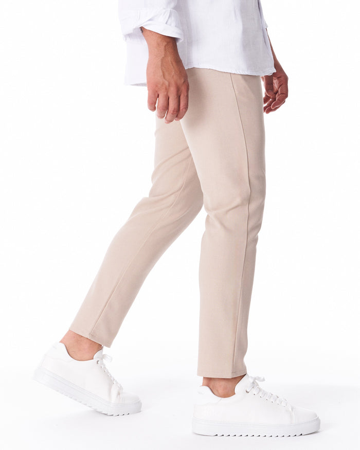 Martin Valen men's beige light-fabric trousers, side mid-thigh view showing a central crease
