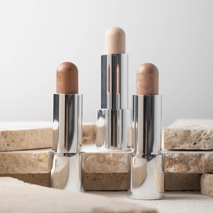Three silver tubes of cream highlighter.