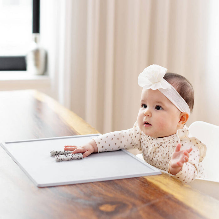 ezpz Mini Placemat in Pewter Gray is a silicone placemat for toddlers that grips to the table #color_pewter