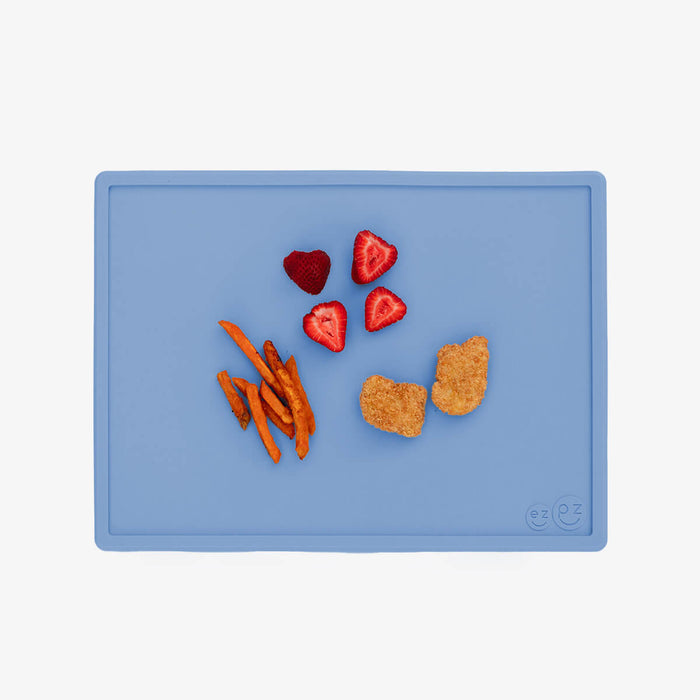 ezpz Mini Placemat in Indigo Blue is a silicone placemat for toddlers that grips to the table #color_indigo