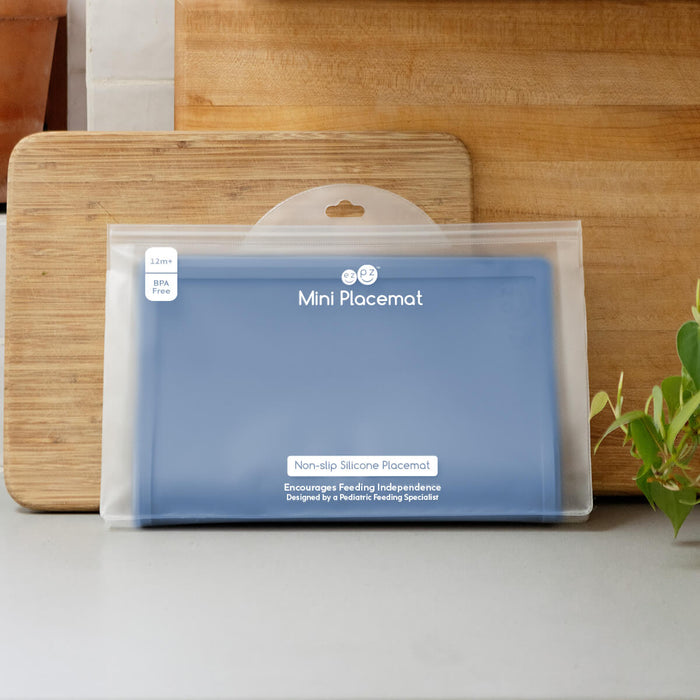 ezpz Mini Placemat in Indigo Blue is a silicone placemat for toddlers that grips to the table #color_indigo