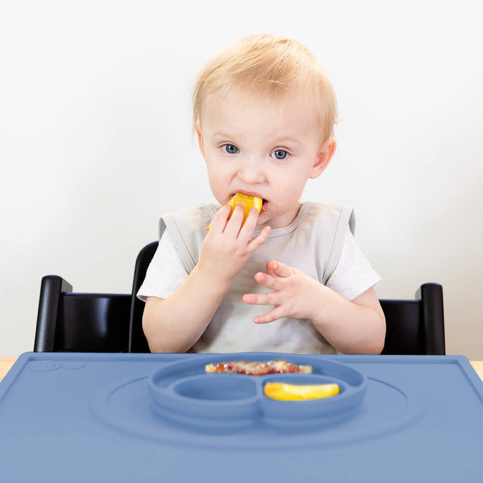 ezpz Mini Placemat in Indigo Blue is a silicone placemat for toddlers that grips to the table #color_indigo