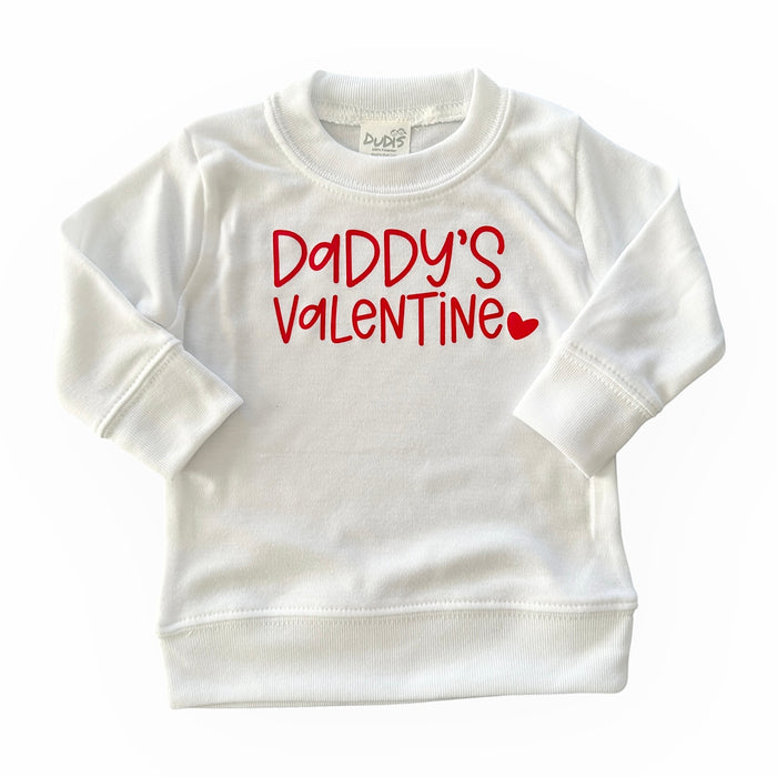 White baby and toddler sweatshirt with 'Daddy's Valentine' in bold red lettering and a heart detail. Perfect for Valentine's Day outfits, combining comfort and style for little ones.