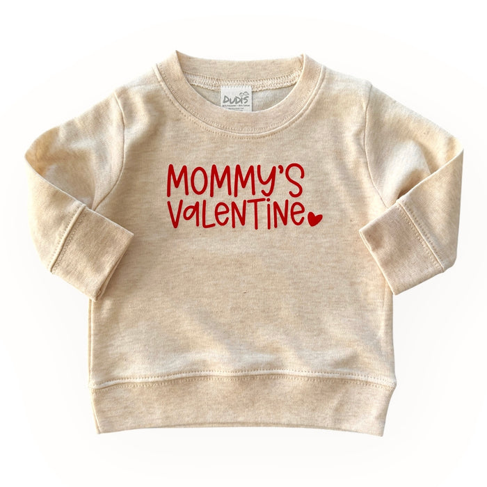 Neutral beige baby and toddler sweatshirt with 'Mommy's Valentine' in bold red lettering and a heart detail. A cozy and adorable Valentine's Day outfit for little ones.
