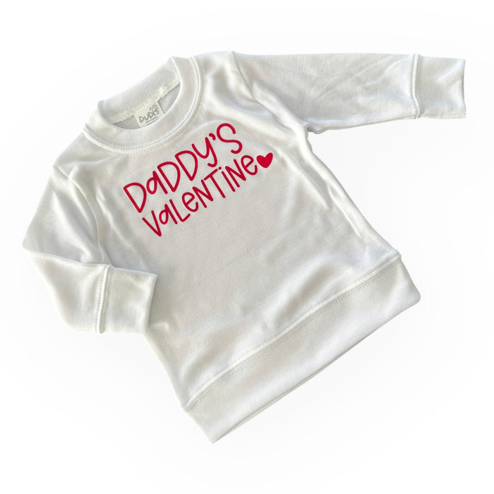 White baby and toddler sweatshirt with 'Daddy's Valentine' in bold red lettering and a heart detail. Perfect for Valentine's Day outfits, combining comfort and style for little ones.