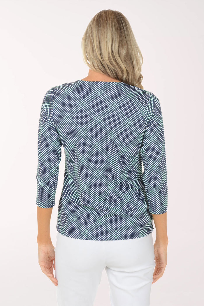 Woman wearing a blue checkered top and white pants on a white background