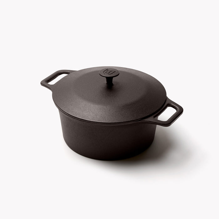 Angled view of the No.8 Field Cast Iron Dutch Oven with lid, shield logo on top and a loop handle on each side
